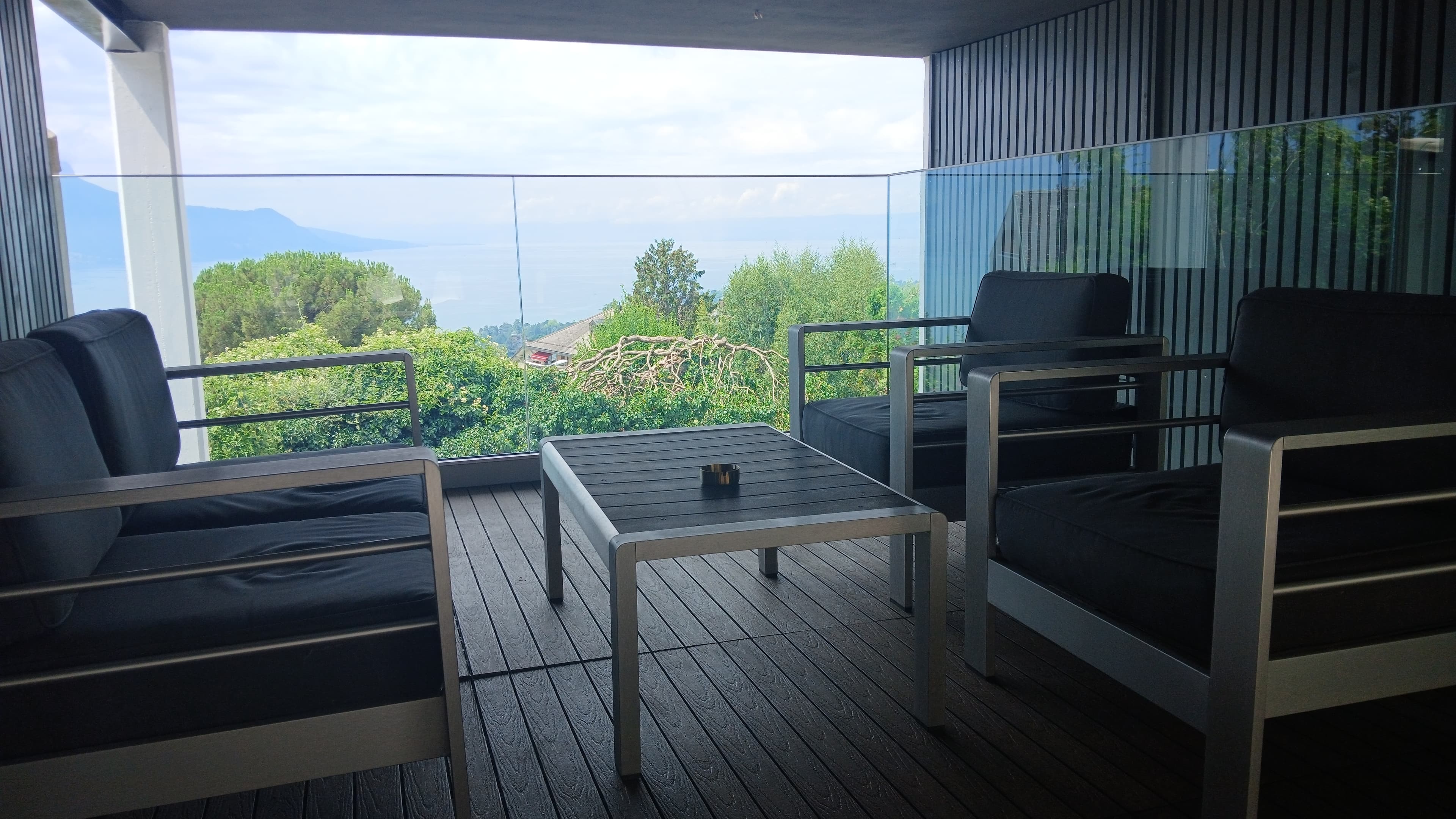 Covered terrace with views of the mountains and Lake Geneva.