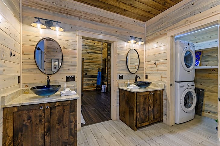 Separate vanities with vessel sinks and full size washer and dryer