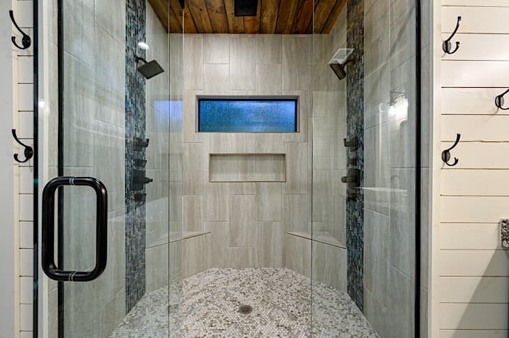 Large walk-in shower has dual heads, body jets and a rain head for a spa-like experience