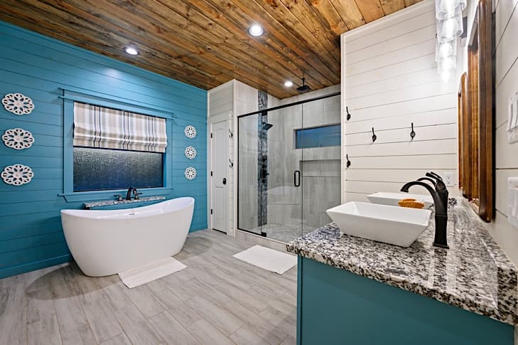 Luxurious bathroom with tiled shower and a double vanity with vessel sinks