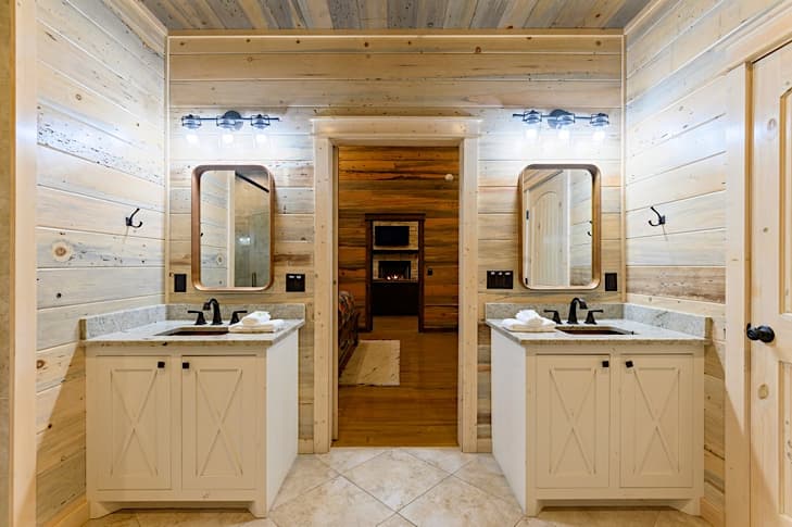 Separate vanities with rustic copper sinks