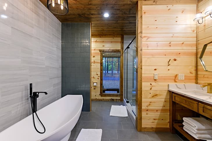Luxurious bathroom with tiled wall and walk-in shower