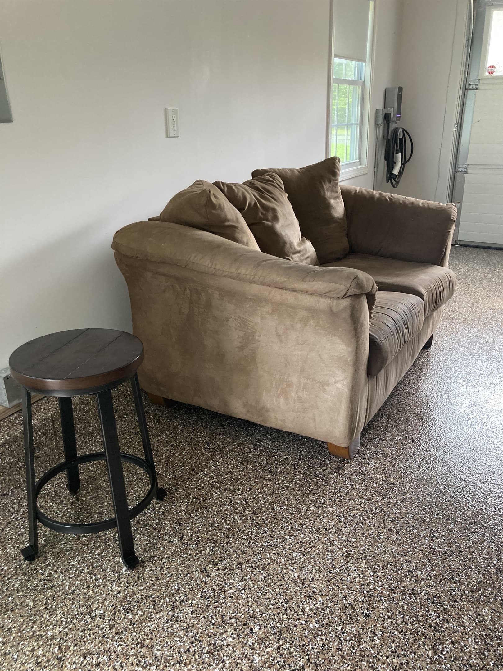 Spectators can sit on the comfy loveseat to watch ping pong and pool in the game room/garage