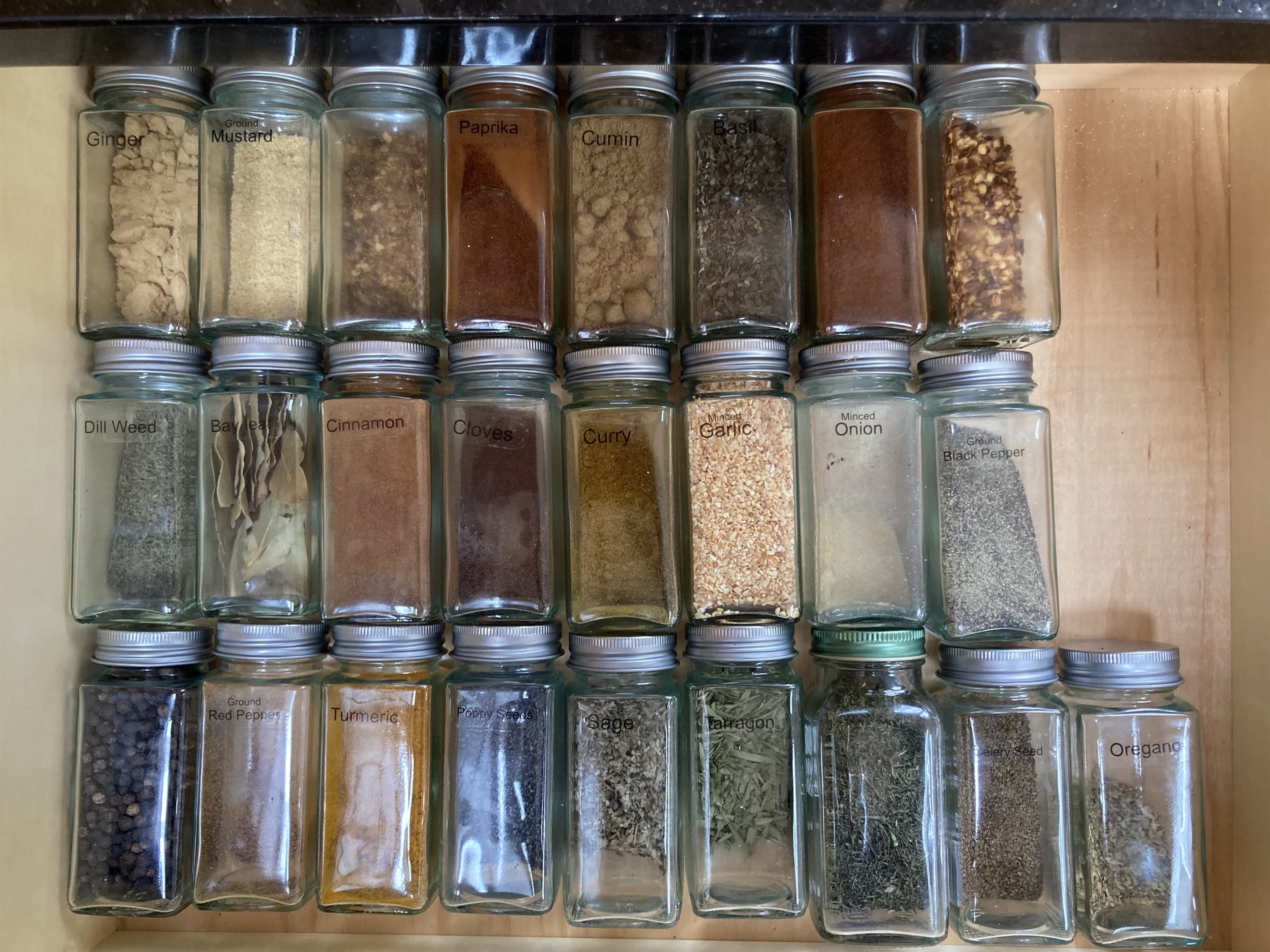 Large assortment of herbs and spices in a drawer in the kitchen