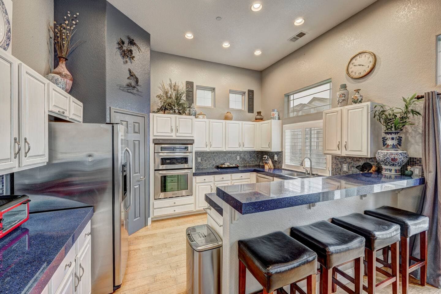 Beautiful well stocked modern kitchen with peninsula and seating for four.