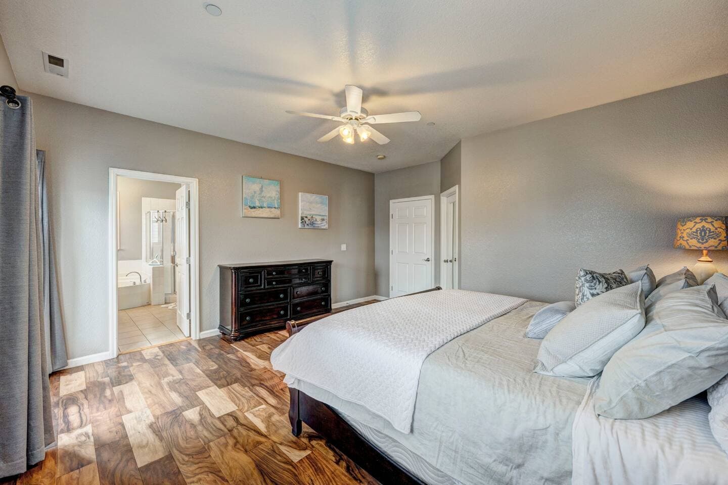 The primary boasts a king bed and dresser for your belongings.