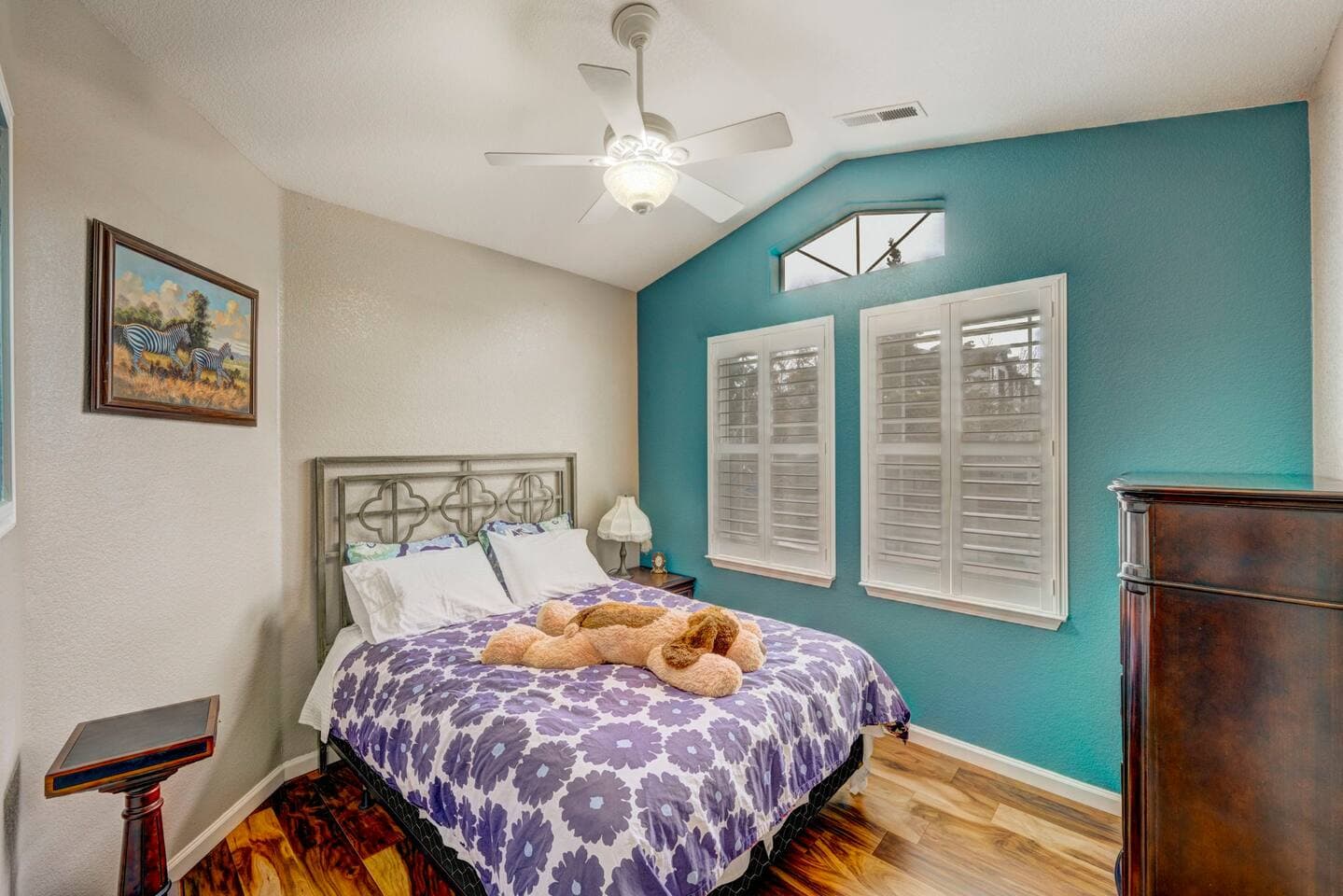 Restful bedroom four with a queen-size bed and ceiling fan.