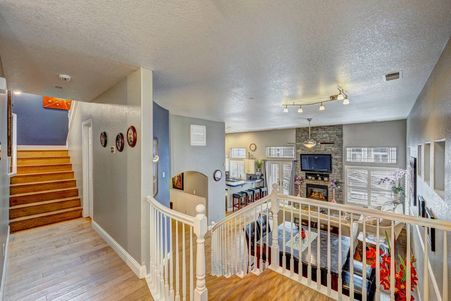 The stairs landing overlooks the open floor plan