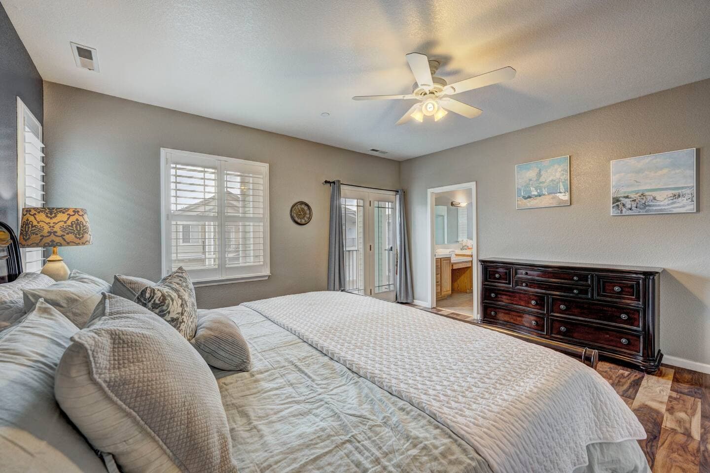 Primary with a balcony and ceiling fan