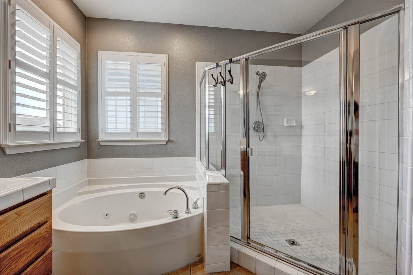 Primary en-suite with walk-in shower and jetted tub.