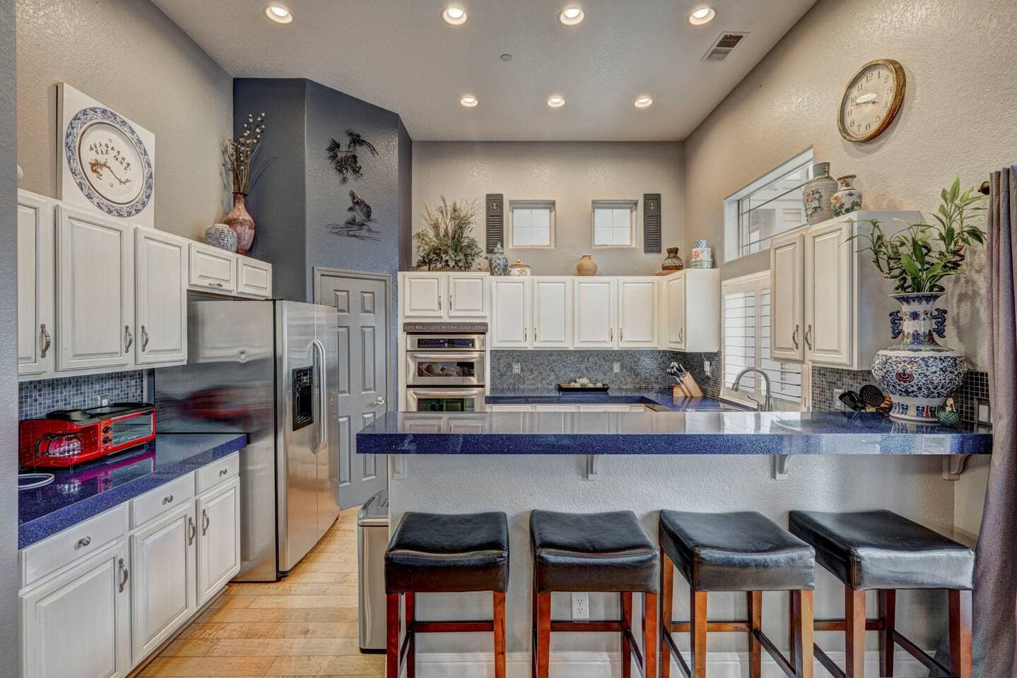 Roomy and bright kitchen to cozy up to the peninsula for a snack or meal.