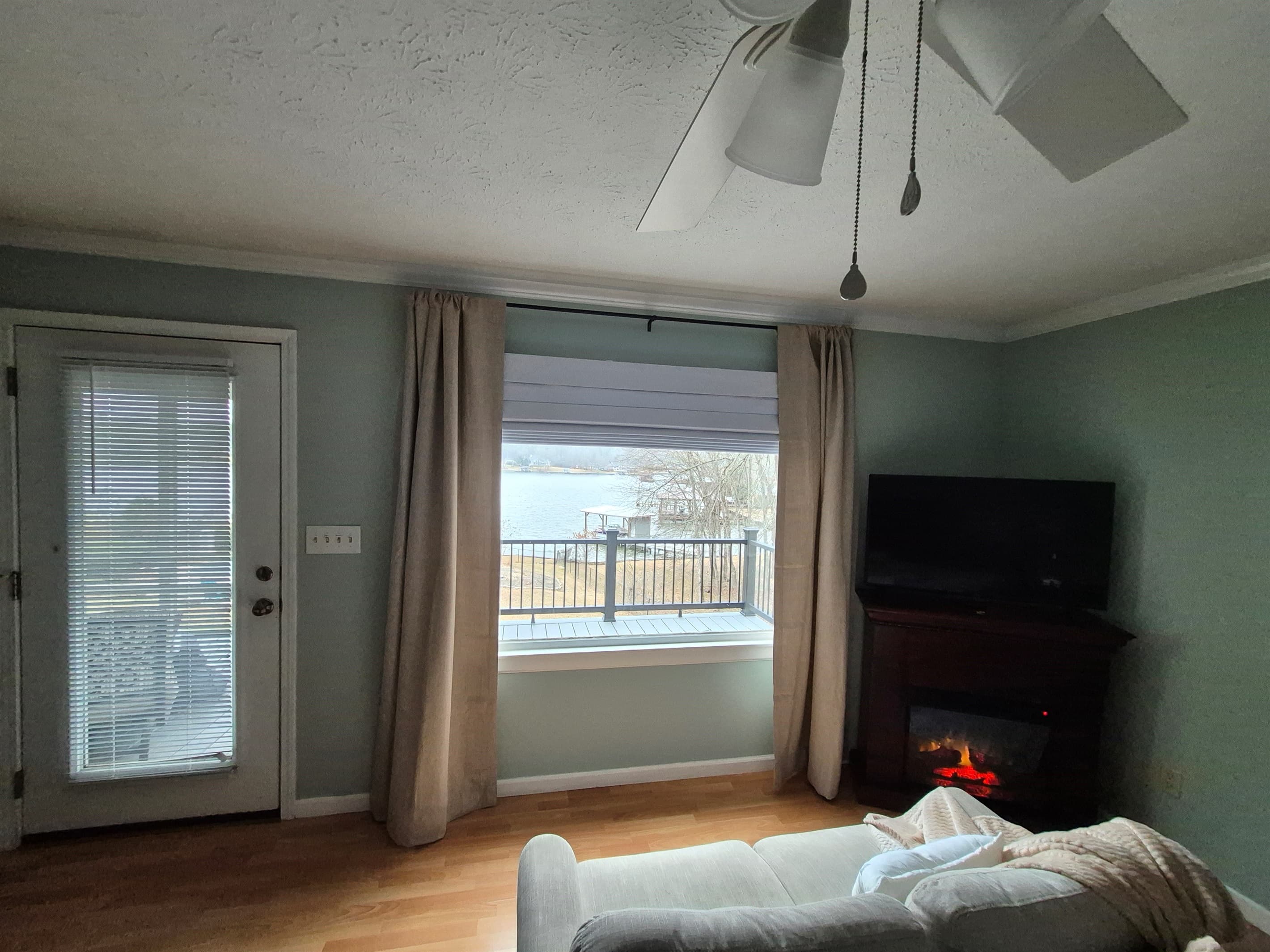 Primary bedroom view to the lake and access directly to the deck and screened in porch