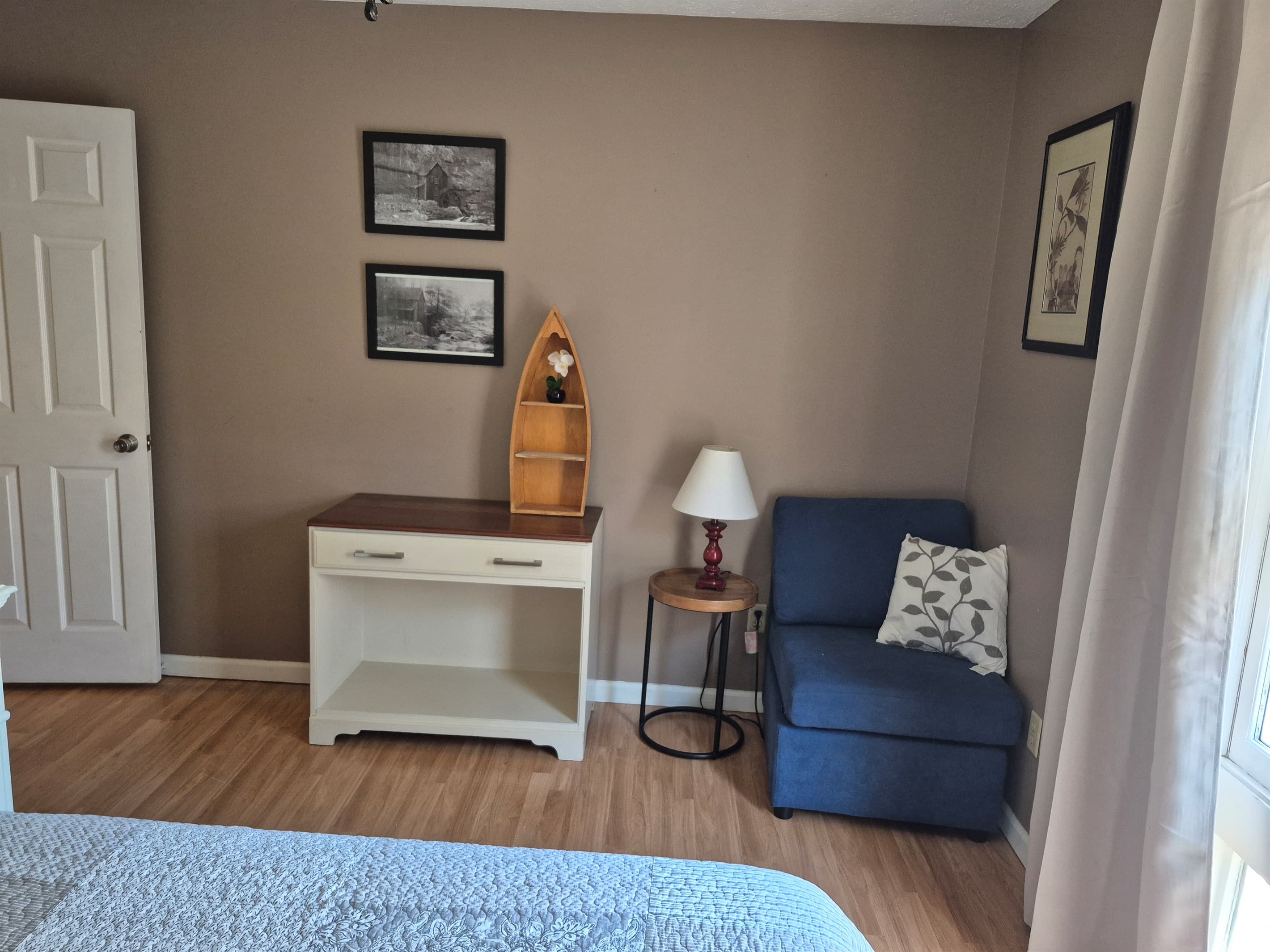 Small seating and storage are in addition to large closet next to queen bed