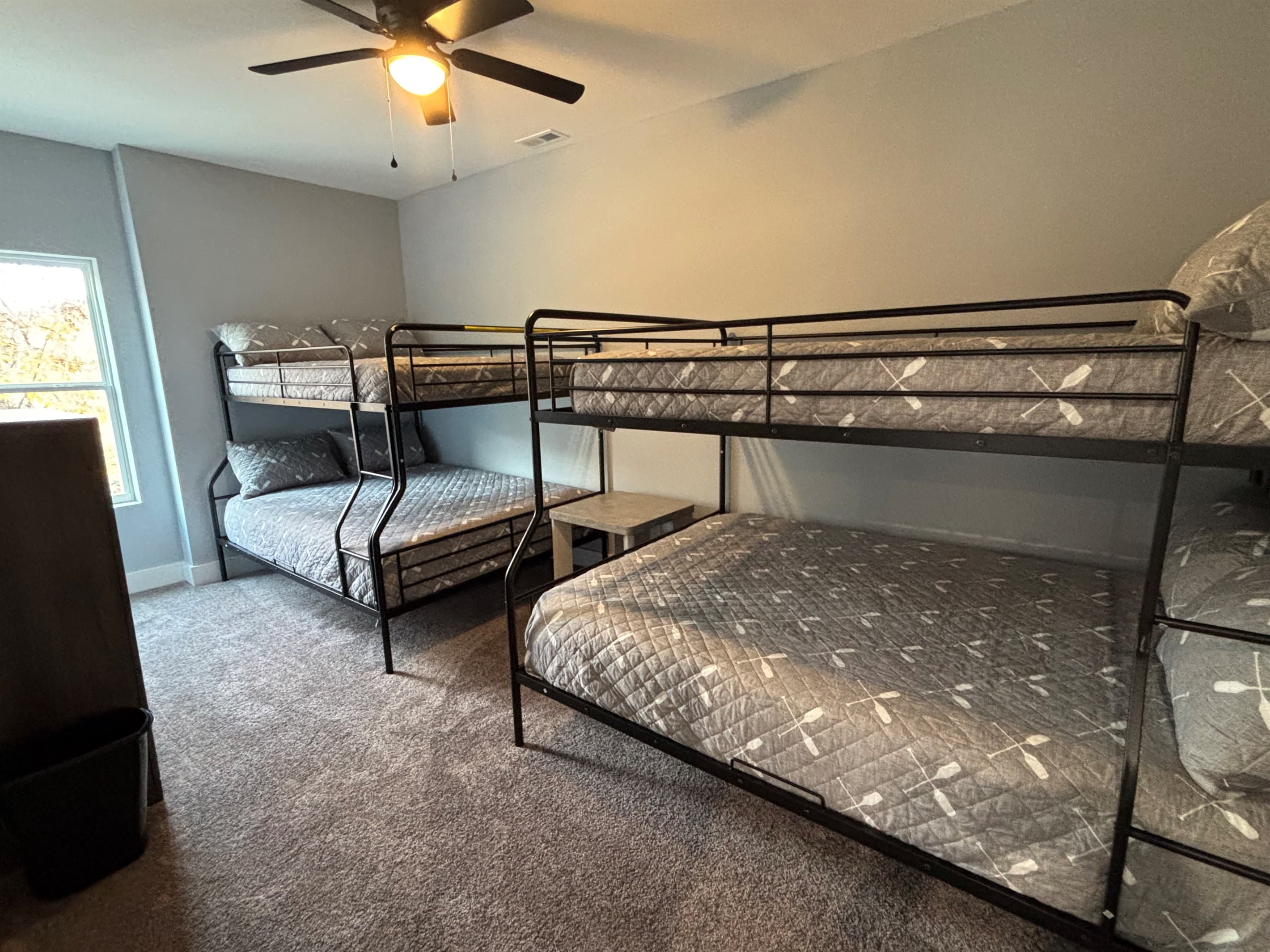 middle floor Bunk Room with ceiling fan and shared bath middle level