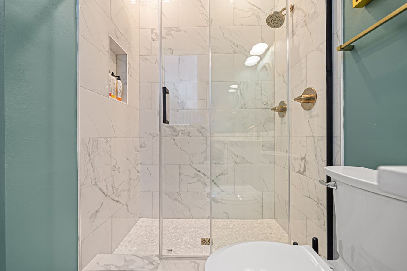 Modern Utility: Sleek, walk-in glass shower with high-pressure rainfall heads for a refreshing start to your day.