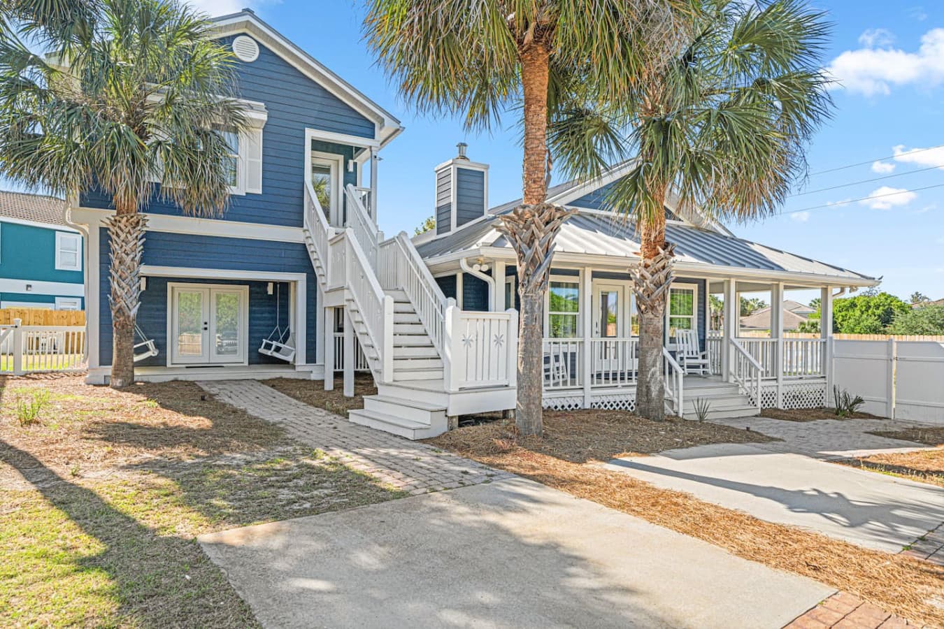 Plenty of parking available at this home. 4 bedrooms are in the main house on the right, including the expansive master suite where the deck and swings are. A separate suite is located upstairs and includes kitchen, bathroom, living and bedroom.