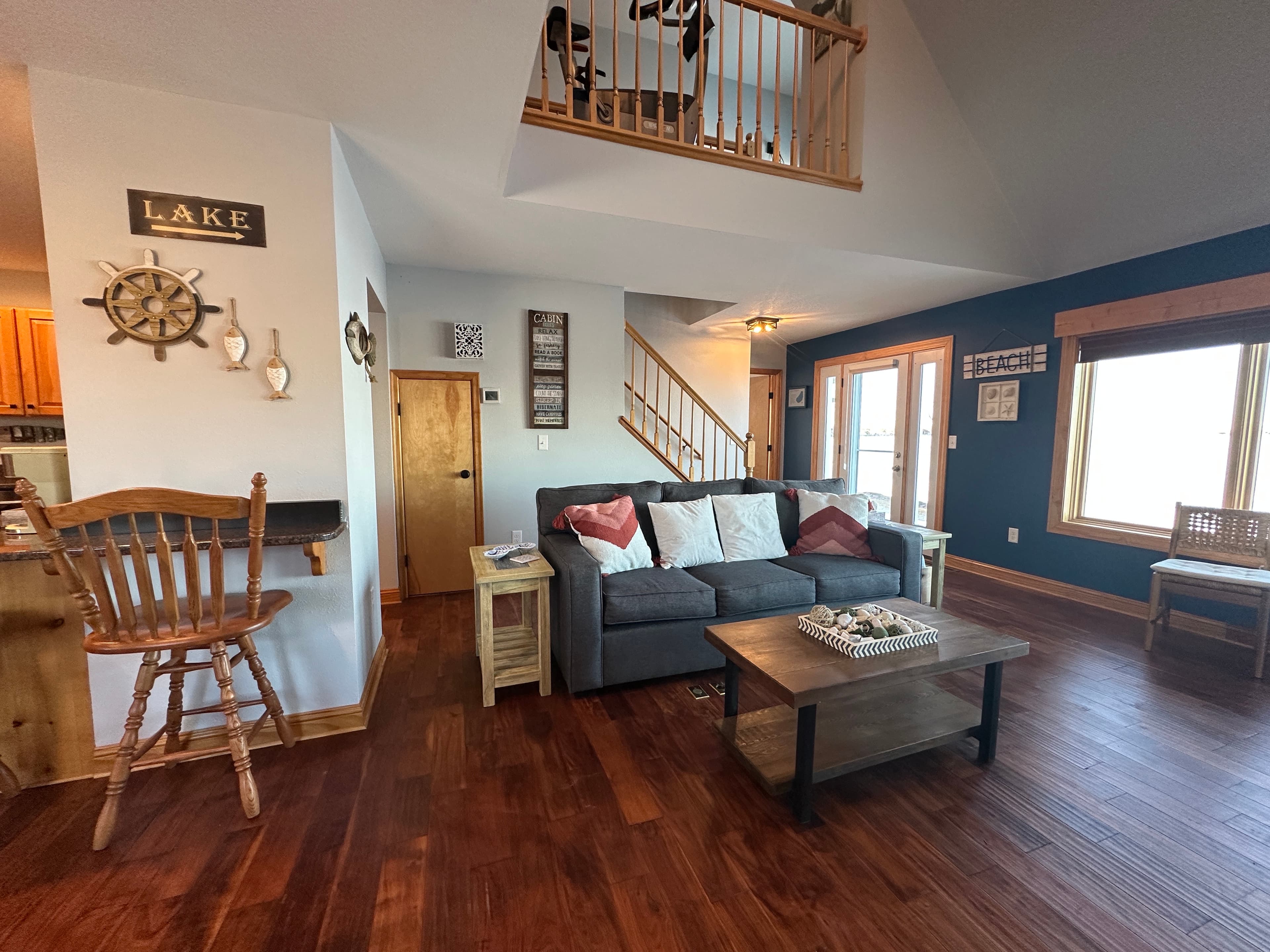 Curl up fireside in the spacious living room, complete with plush sofas and lake views just beyond the windows or watch the 65 inch tv. 
