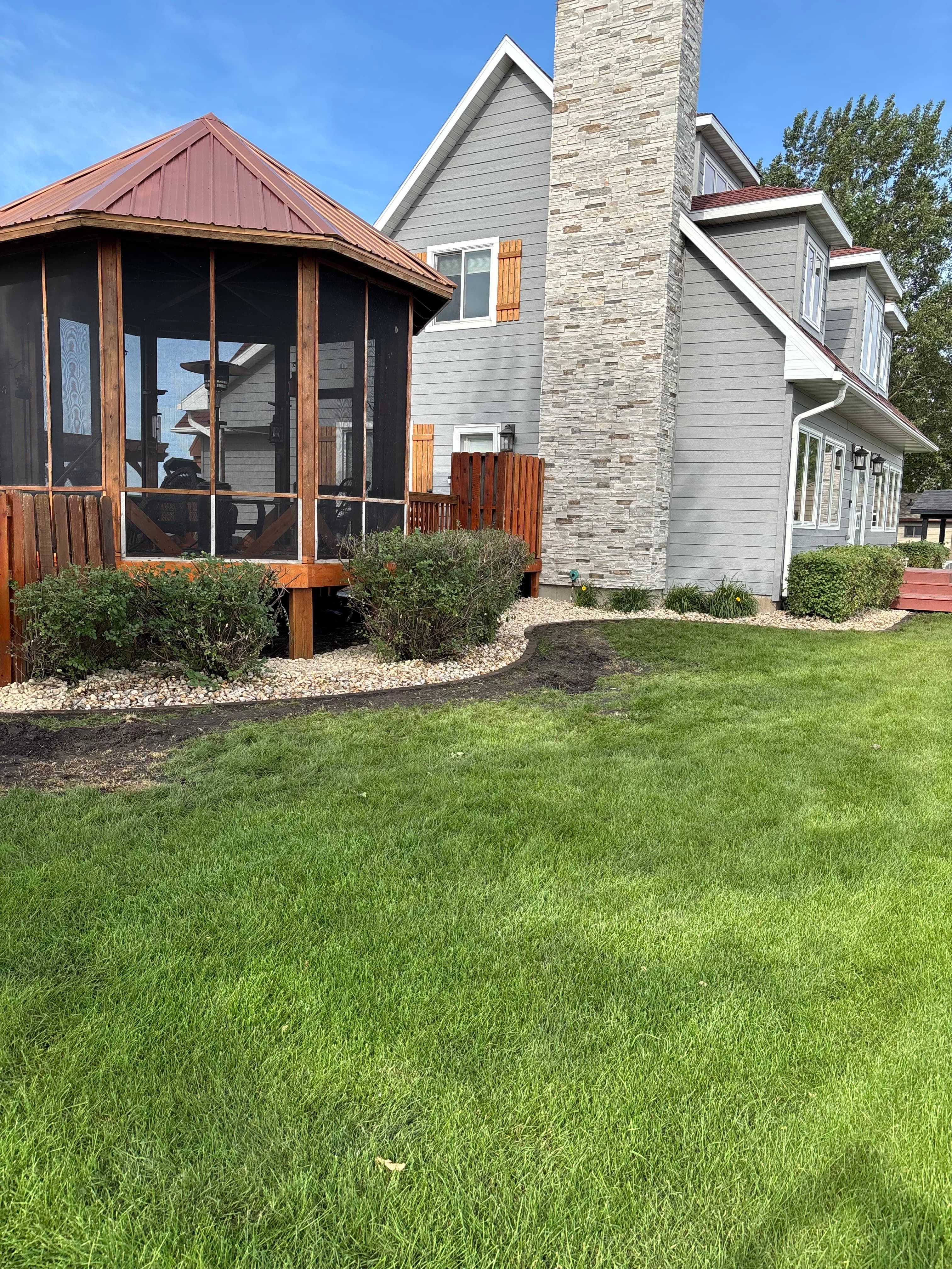 Lush landscaping now wraps around the lakeside gazebo, creating a cozy retreat just steps from the water. Grab a book, pour a drink, and settle into your own private slice of lake life.
