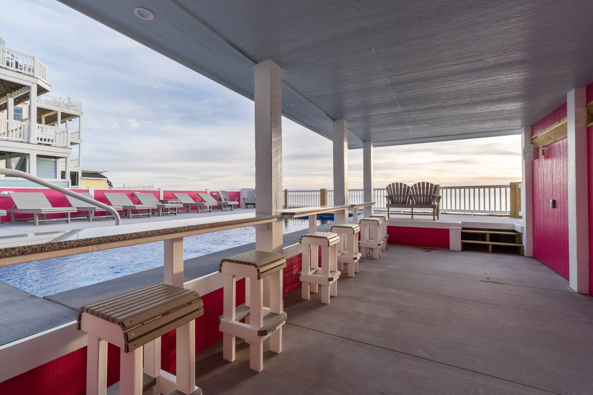 Multi-Level Poolside Deck with Bar Seating in Cabana