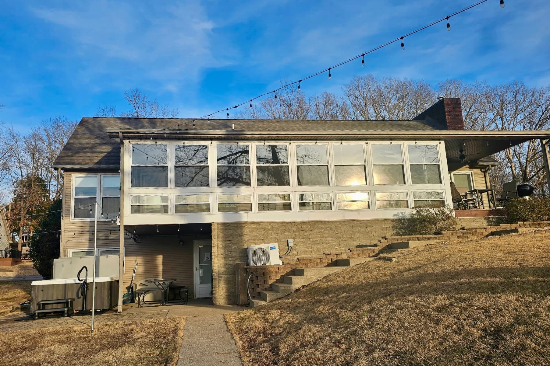 Hot tub is on the lower level- accessible from sunroom > sidewalk > hot tub.  Basement is locked.