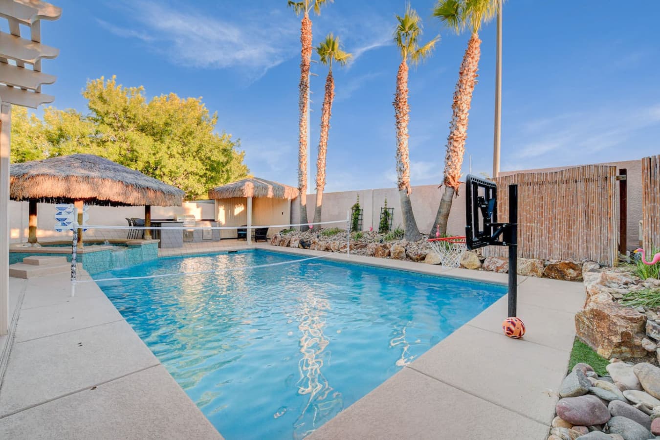 Private heated pool with palm trees, lounge seating— perfect for relaxing Las Vegas days