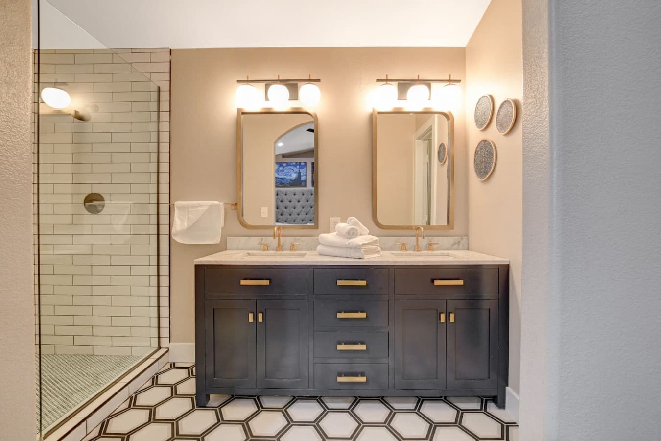 Updated bathroom with double vanity, modern fixtures, and fresh towels provided