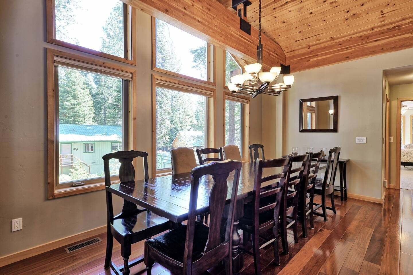 The large dining room table seats eight guests. Two bar stools are available for additional seating at the counter.
