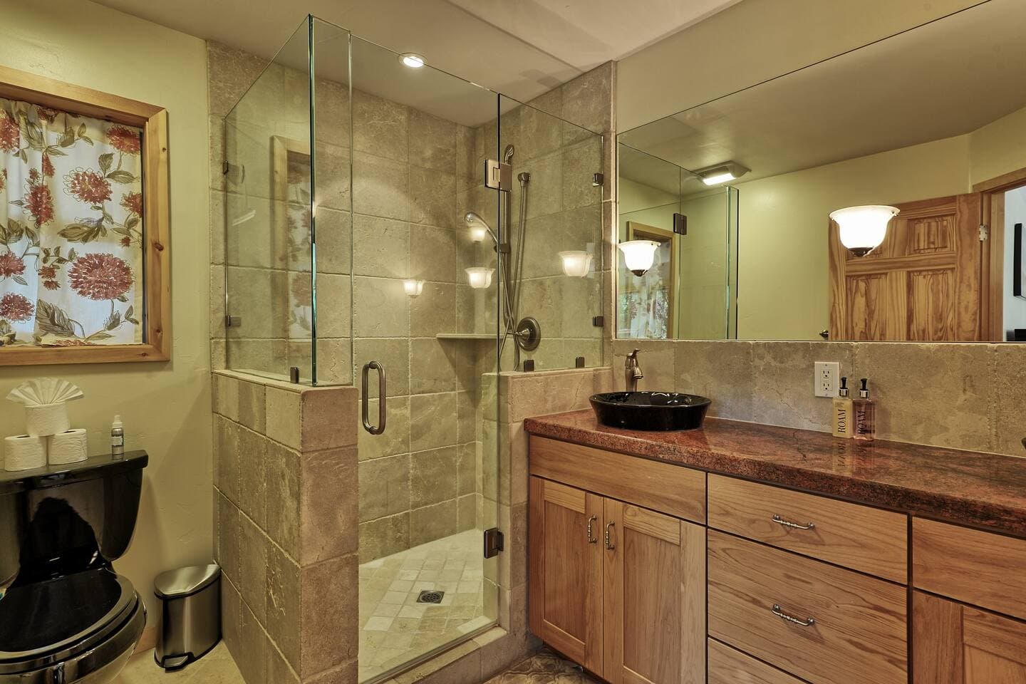 The elegant primary bathroom features a luxurious walk-in shower and designer sinks.