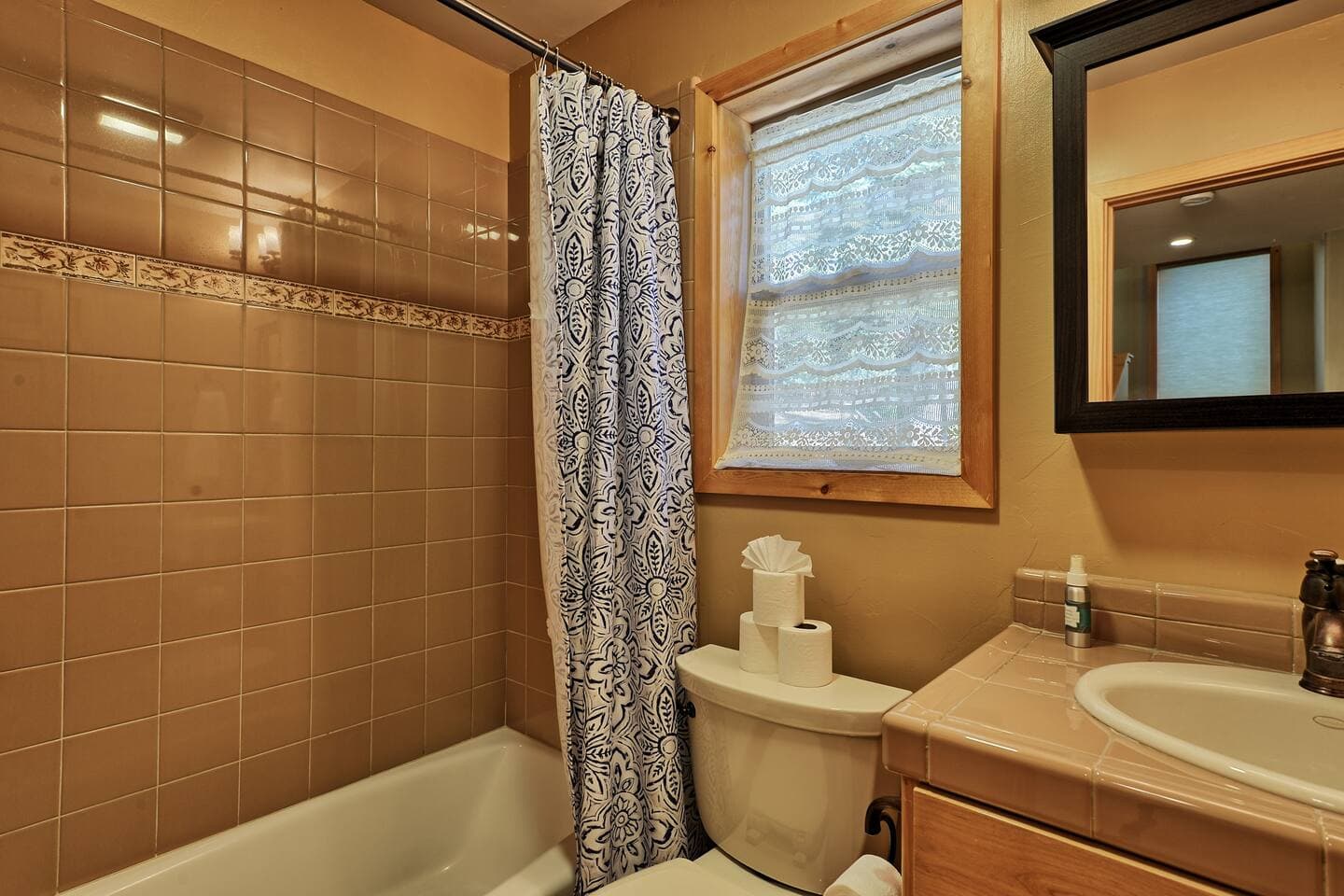 A full bathroom located downstairs with a shower/tub combo