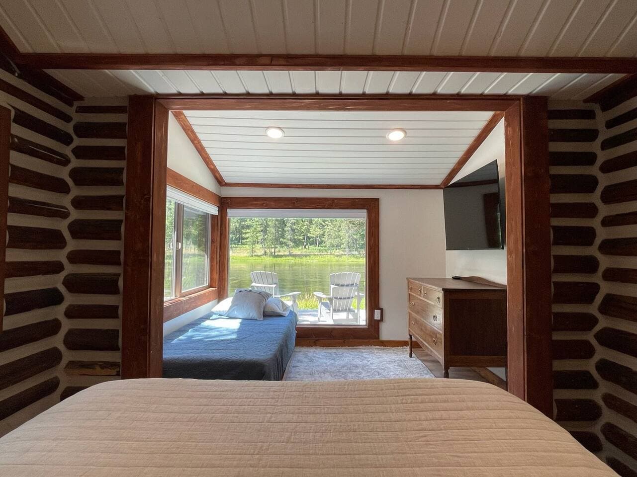The primary bedroom has great views while laying on the queen size bed.