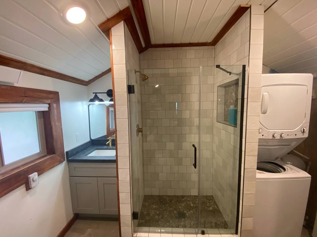The bathroom has a large walk-in shower. The washer and dryer are located here as well.