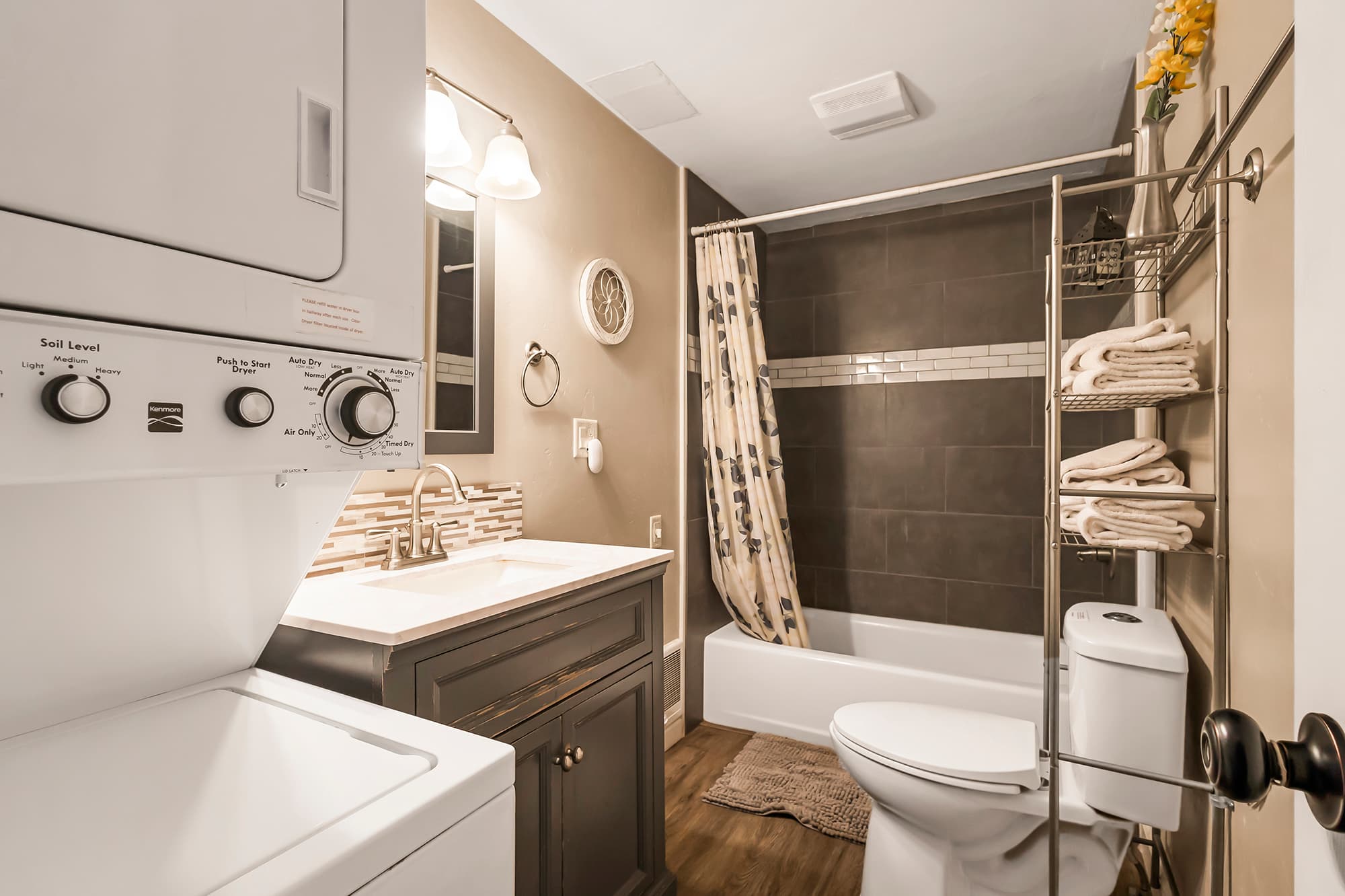 Downstairs bathroom 1 with tub/shower combo and washer and dryer.