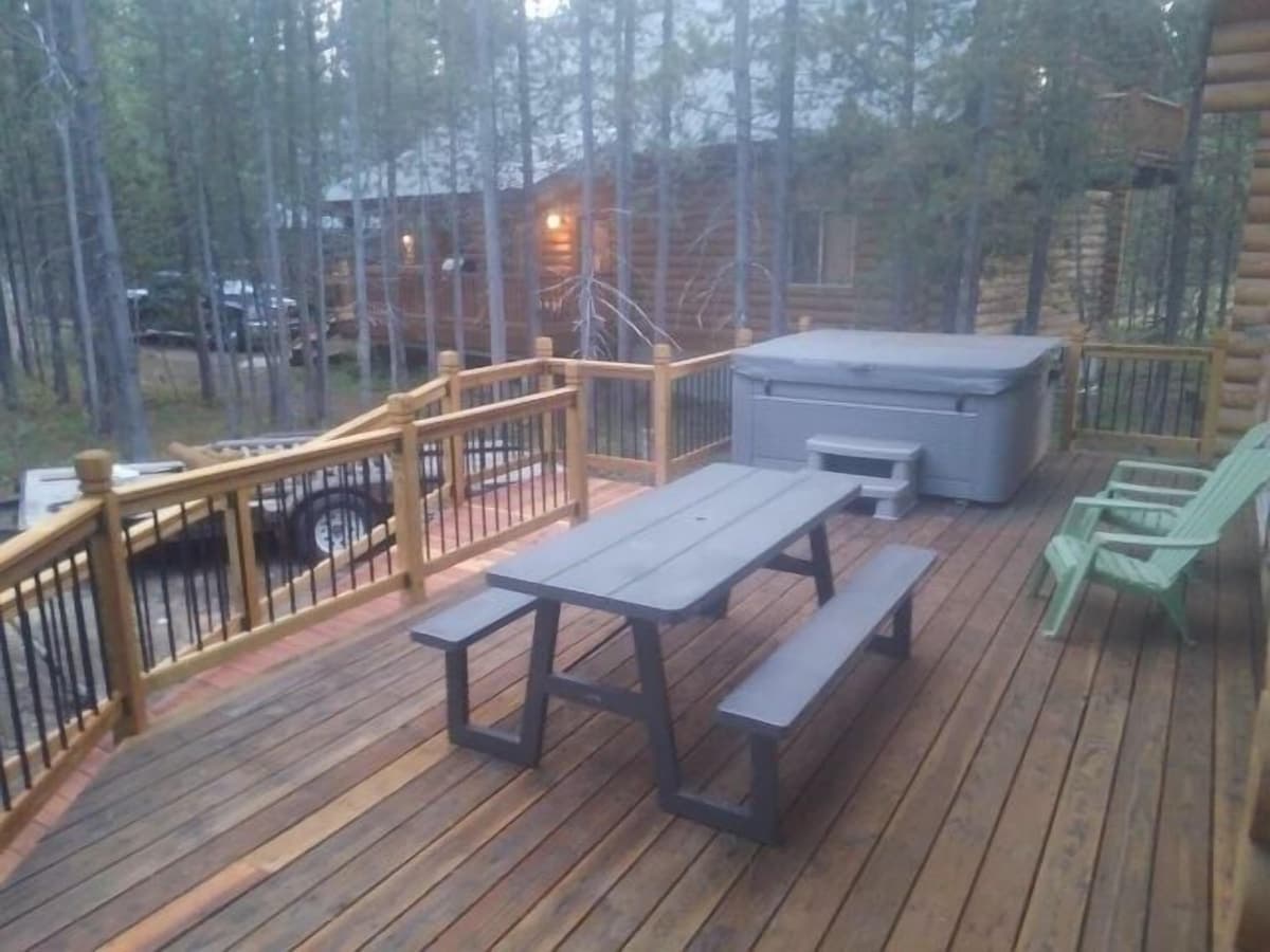 Back deck, with seating, a place to dine, and a hot tub. "The hot tub was a real hit with everyone!" - Decorah W. 