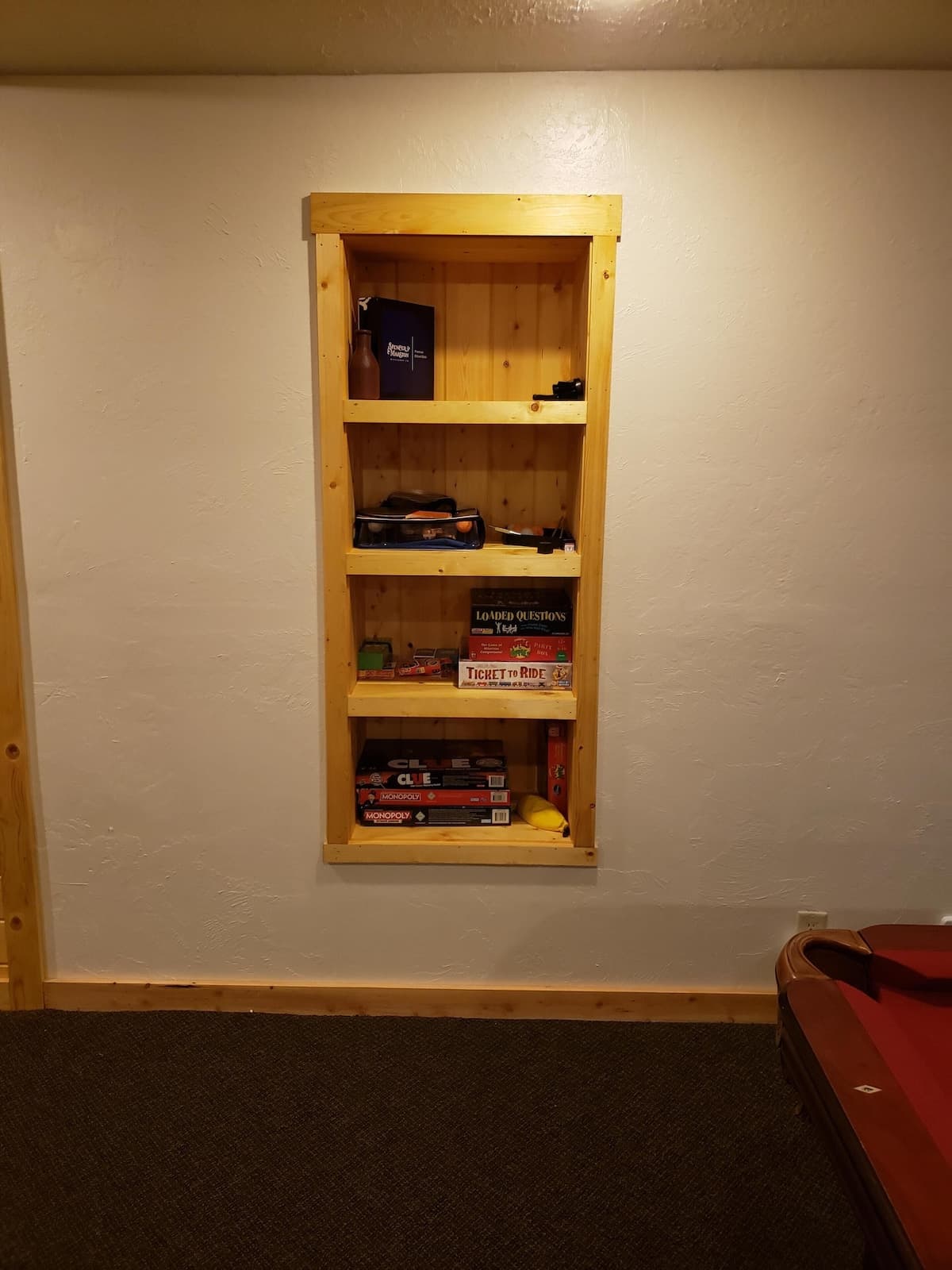 Basement at Yellowstone Cabin. The pool table has a ping pong table top and there are built in shelves for games and such.