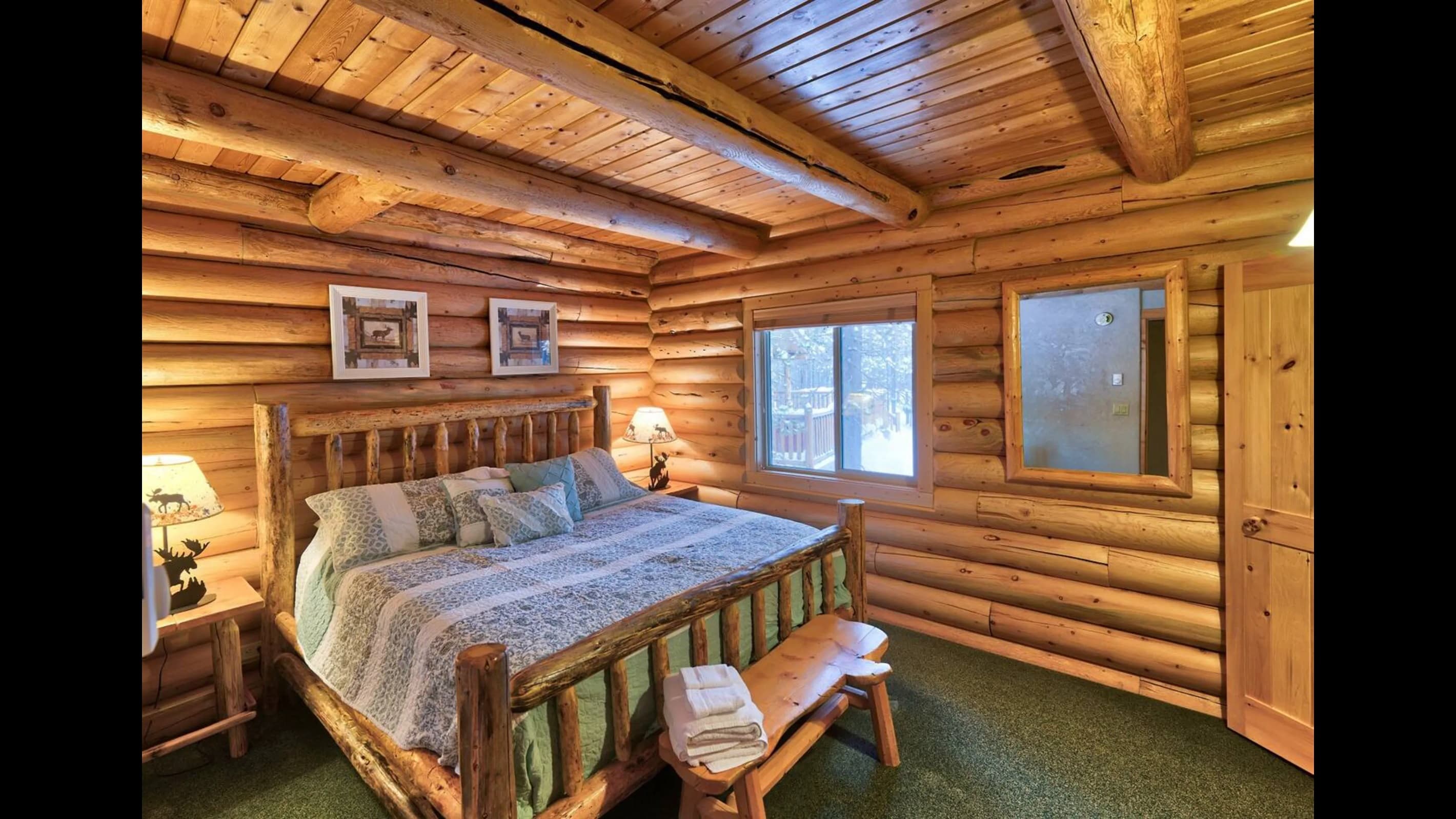Bedroom 2: Centered in the room a sturdy king-sized wooden bed promises restful slumber as sunlight streams through a window.
