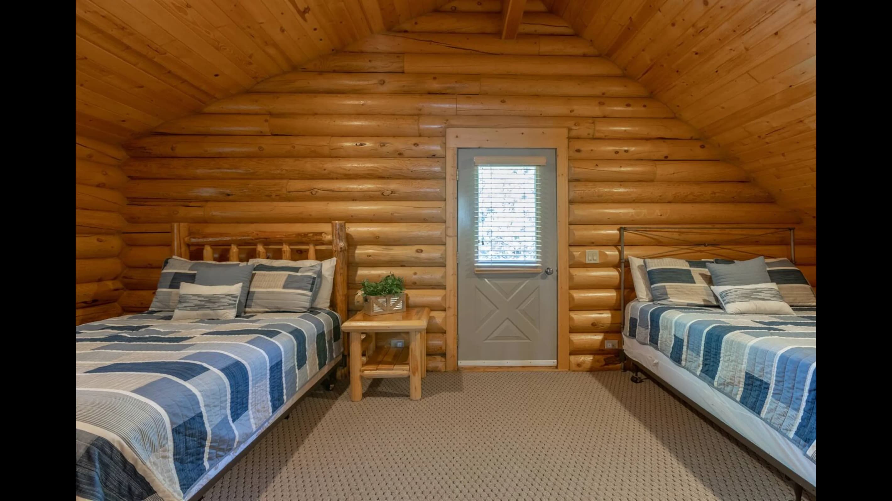 The wooden walls are crafted with polished wooden logs, creating an inviting ambiance.