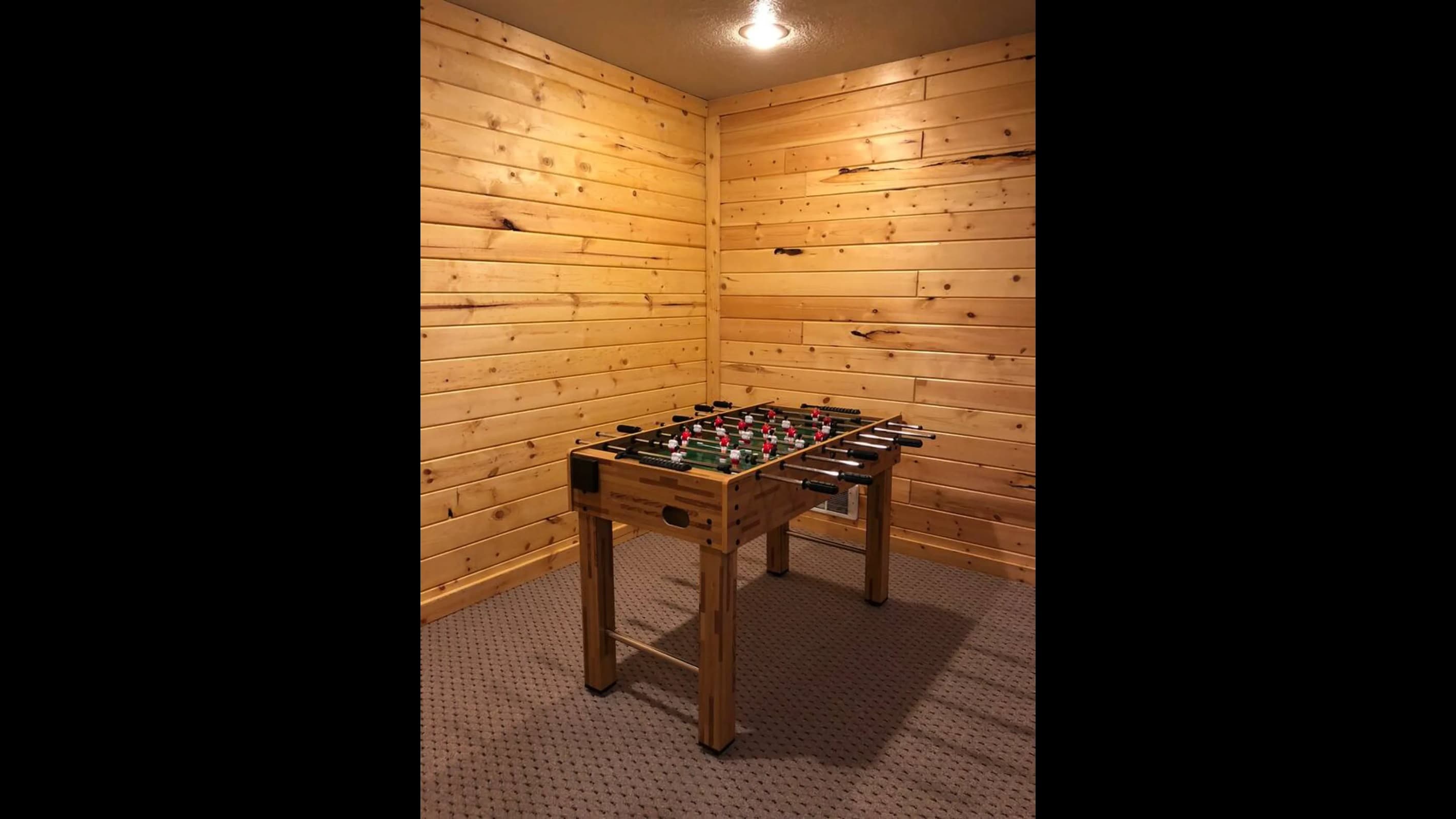 The foosball table is ready for a good game to be enjoyed.