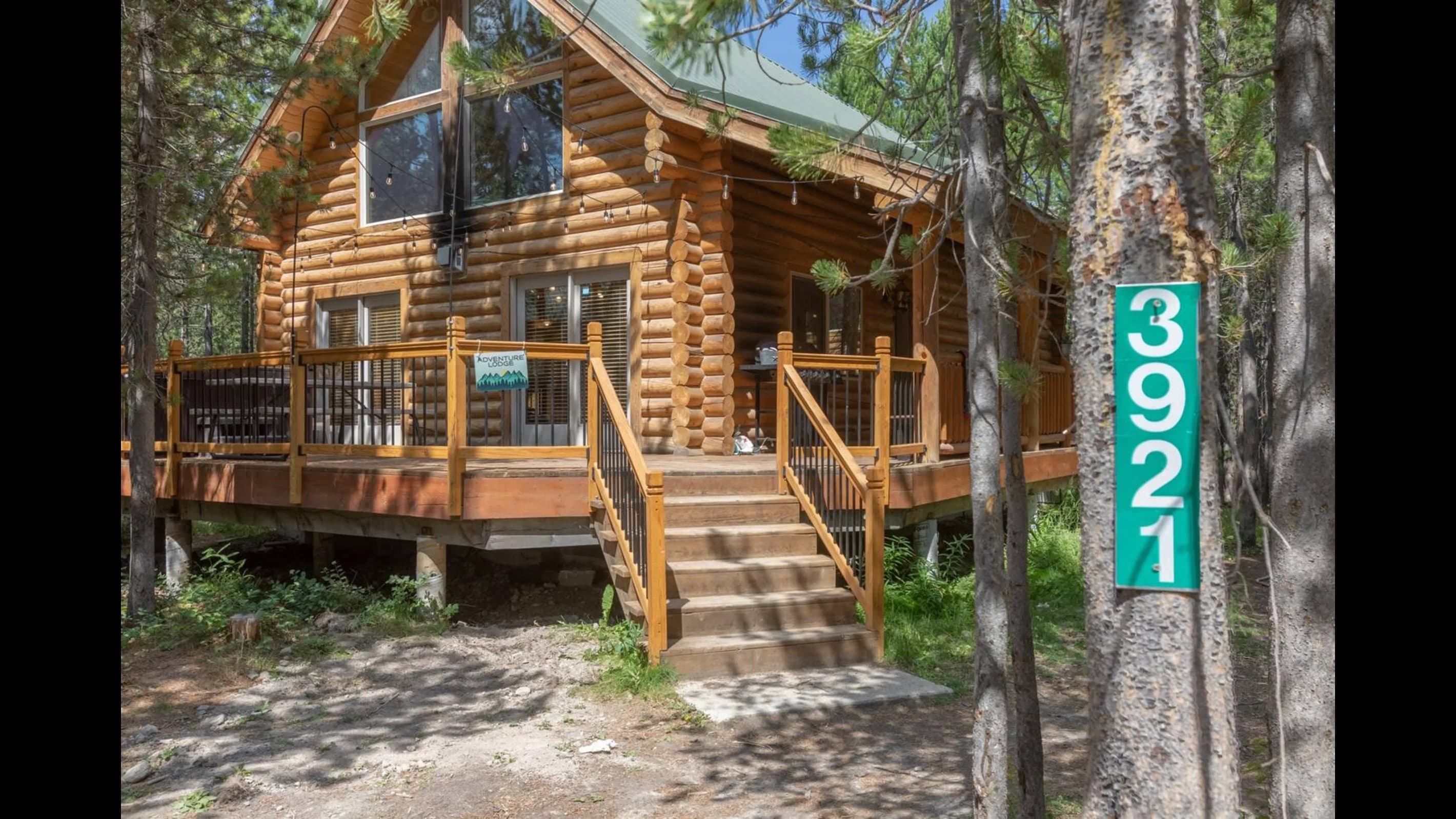 Sunlight bathes the cabin while the surrounding foliage flourishes with lush vibrancy, signaling the onset of fall.