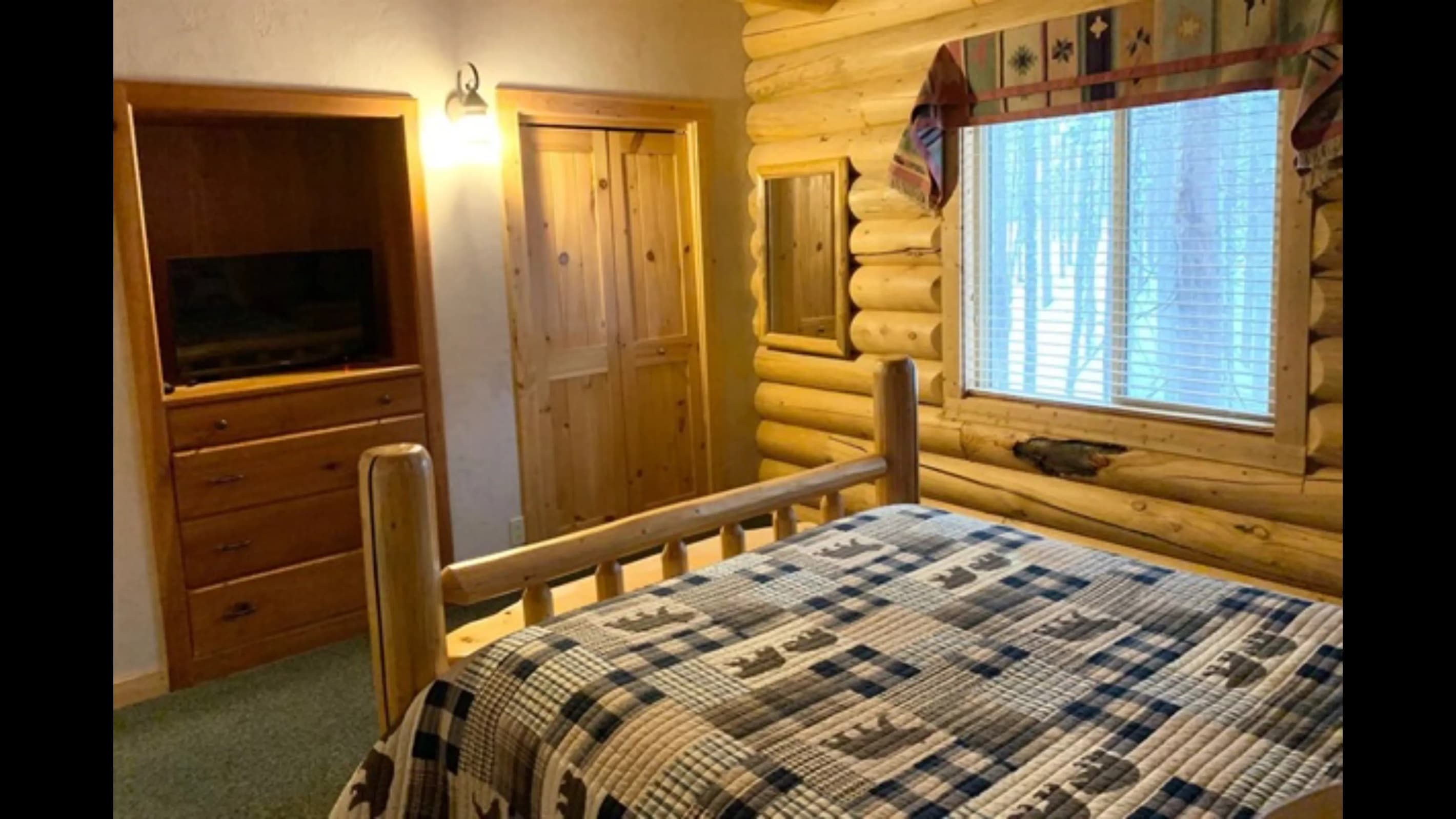 Log cabin-style bedrooms with log-hewn beds.