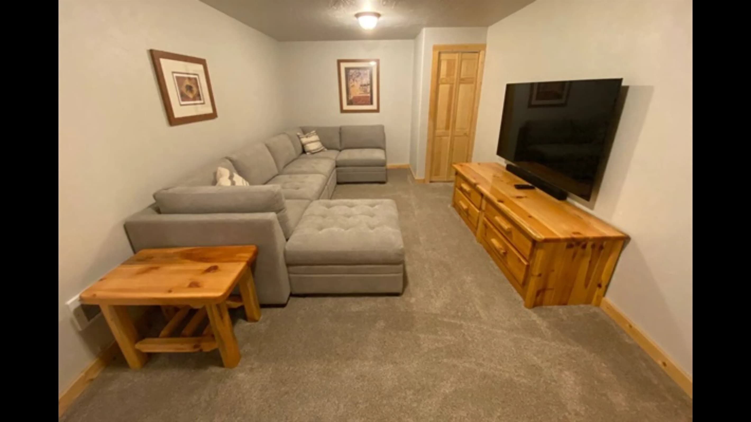 Large sectional in the basement, perfect for cozy gatherings while watching a show.