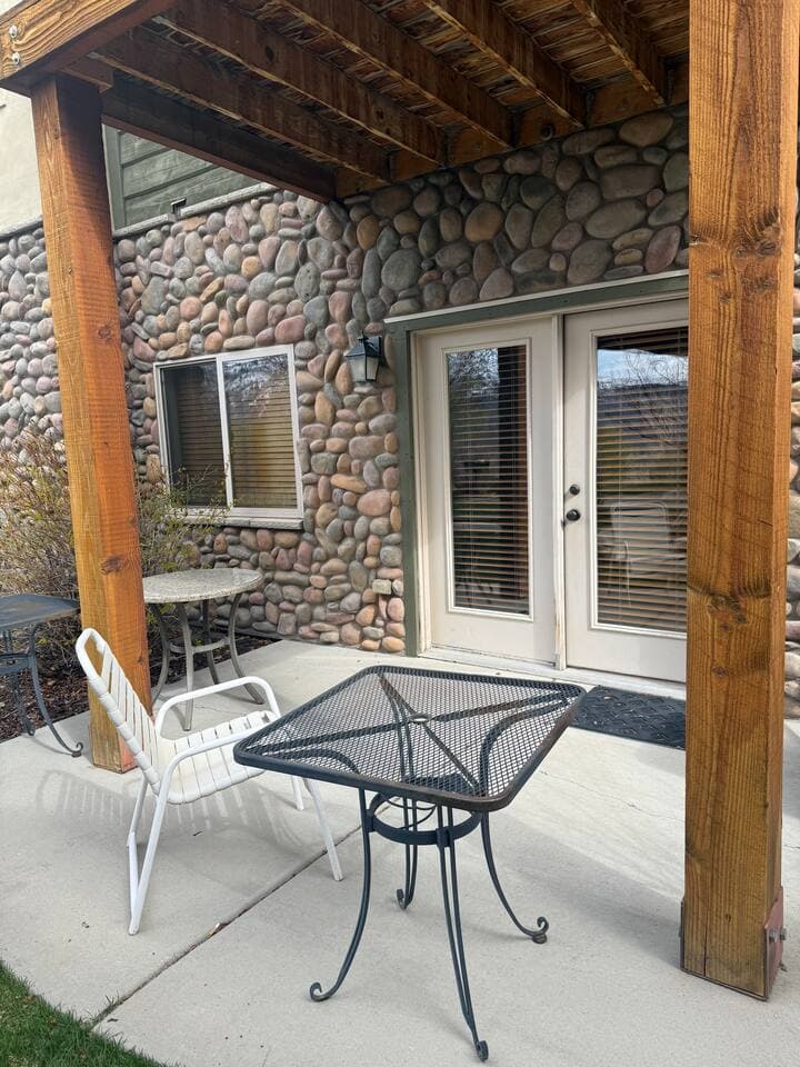 The outdoor patio provides a casual gathering space with tables and chairs—great for morning coffee, afternoon snacks, or simply unwinding outdoors.