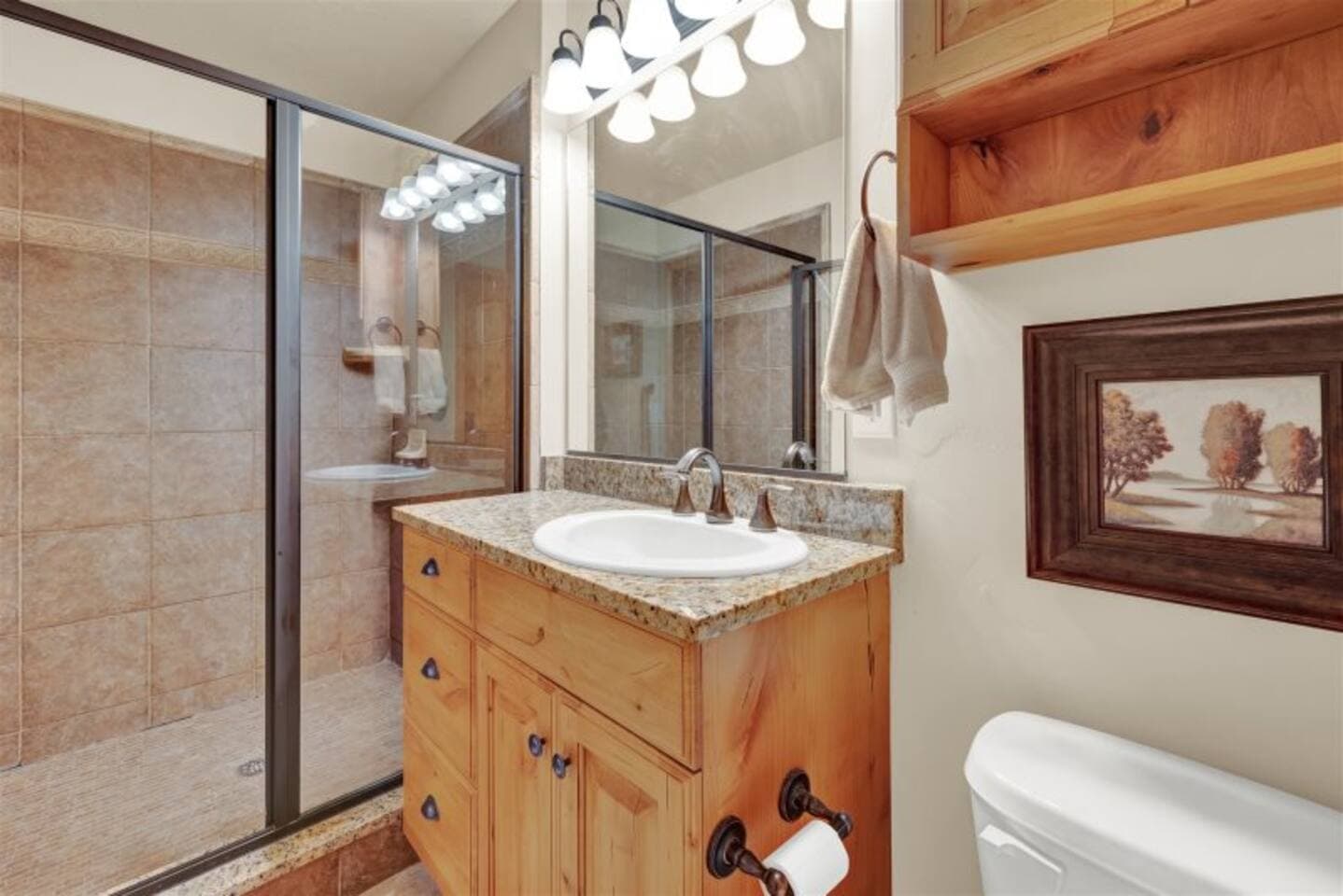 Full bathroom with walk-in glass shower.