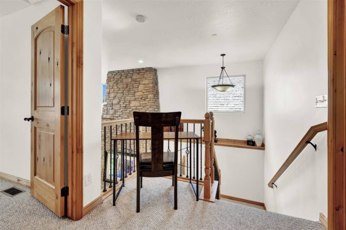 Lofted workspace with a desk and chair, perched above the living room—perfect for remote work or journaling.