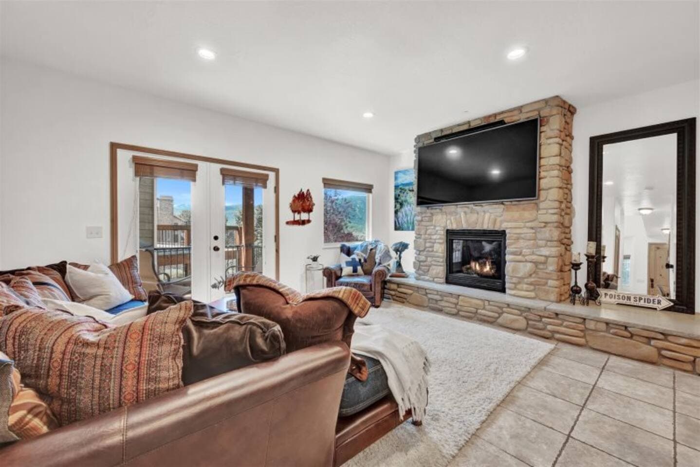 Family room featuring a deep, cozy sectional, fire place, and a big-screen TV.