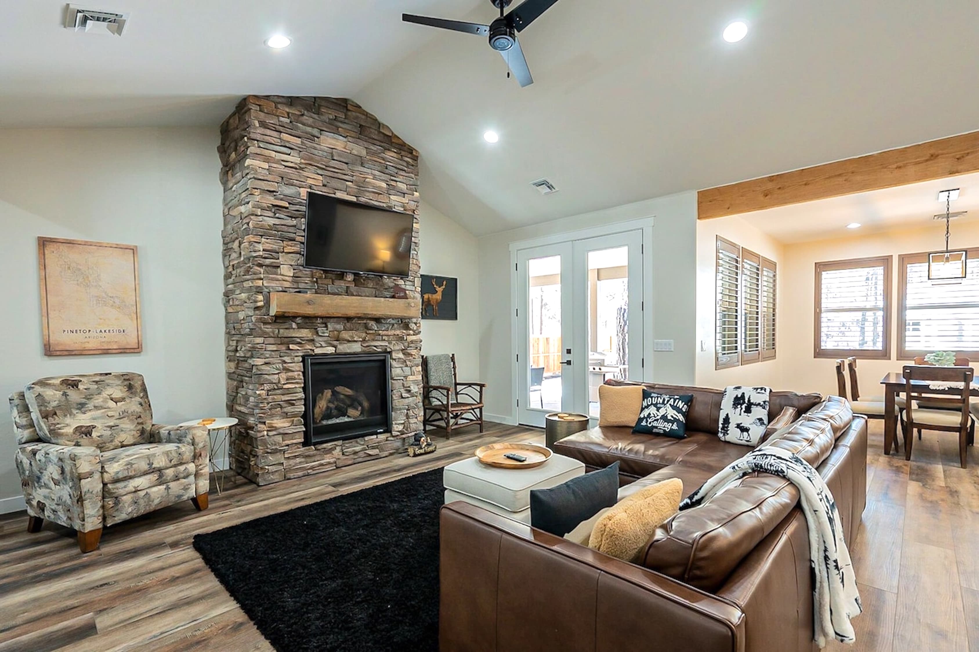 With its soaring brick fireplace and open floor plan, this living room feels both grand and grounded—a perfect blend of light, warmth, and comfort.