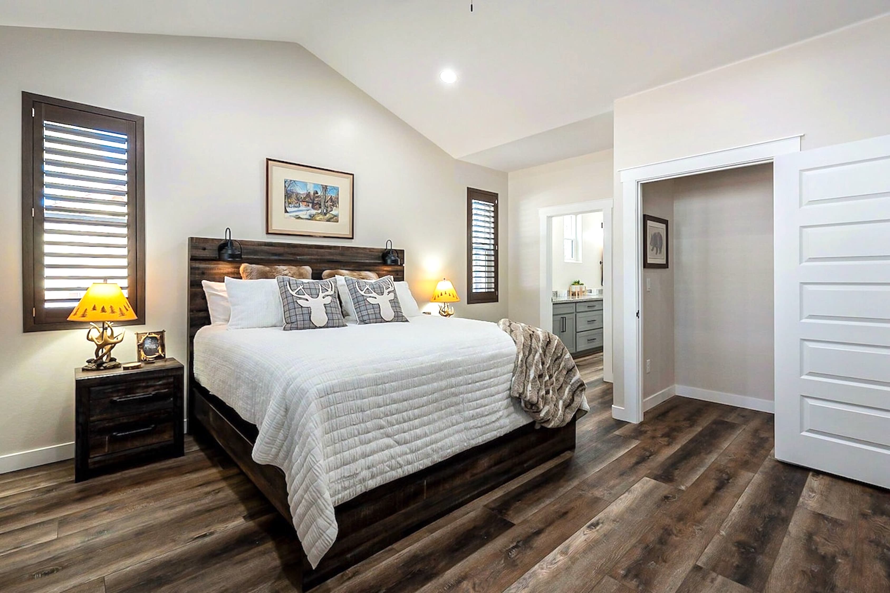 Cozy modern bedroom with rustic wood accents, warm lighting, and a peaceful neutral palette.