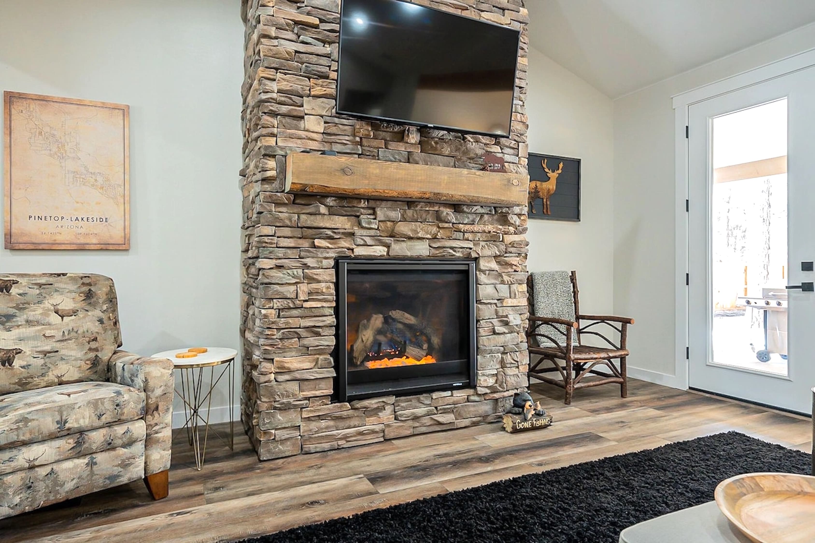 Cozy up by the crackling fire and unwind with your favorite show — mountain comfort meets rustic elegance.