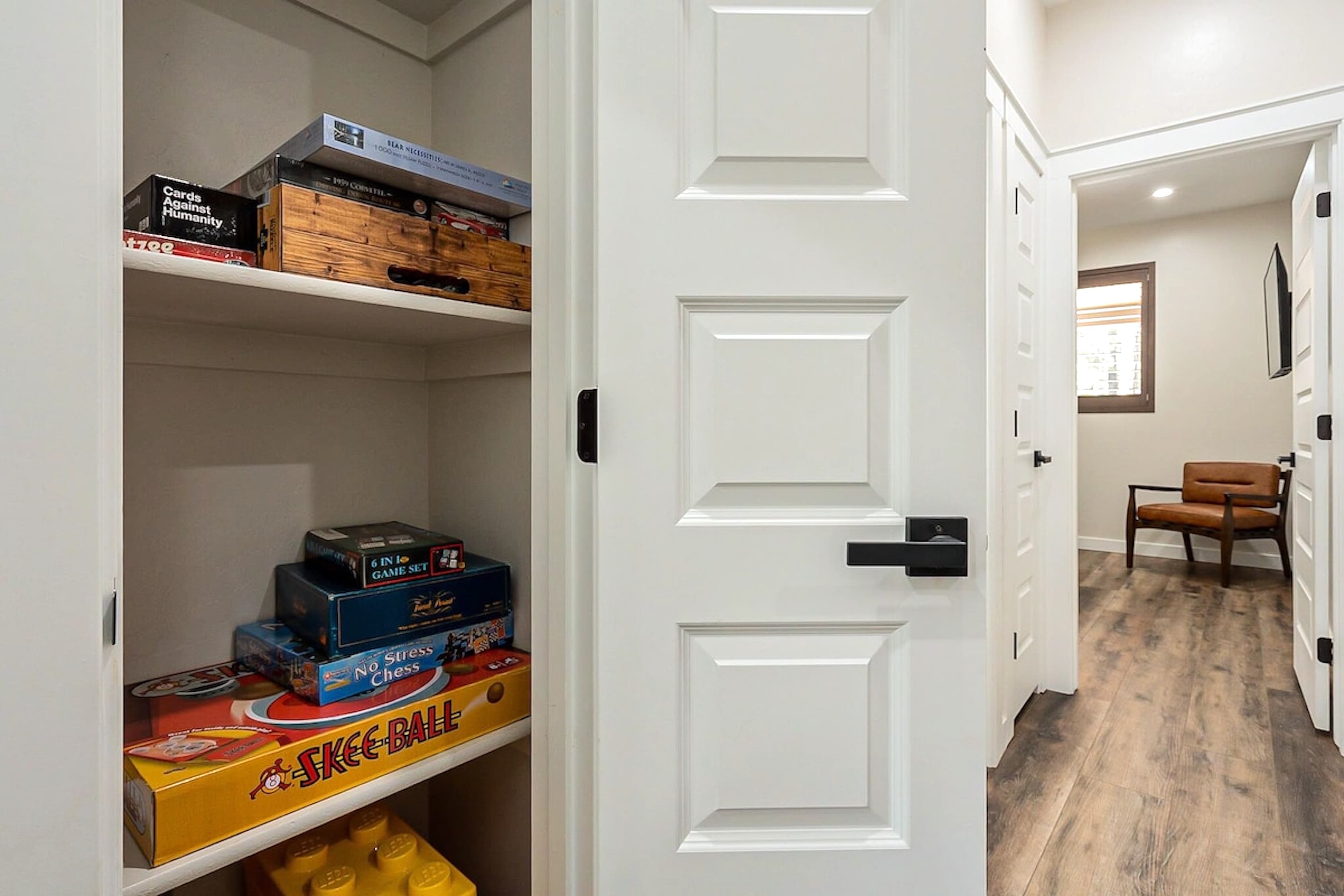 Laughter lives here — a full shelf of classic games and cozy fun for unforgettable family nights by the fire.