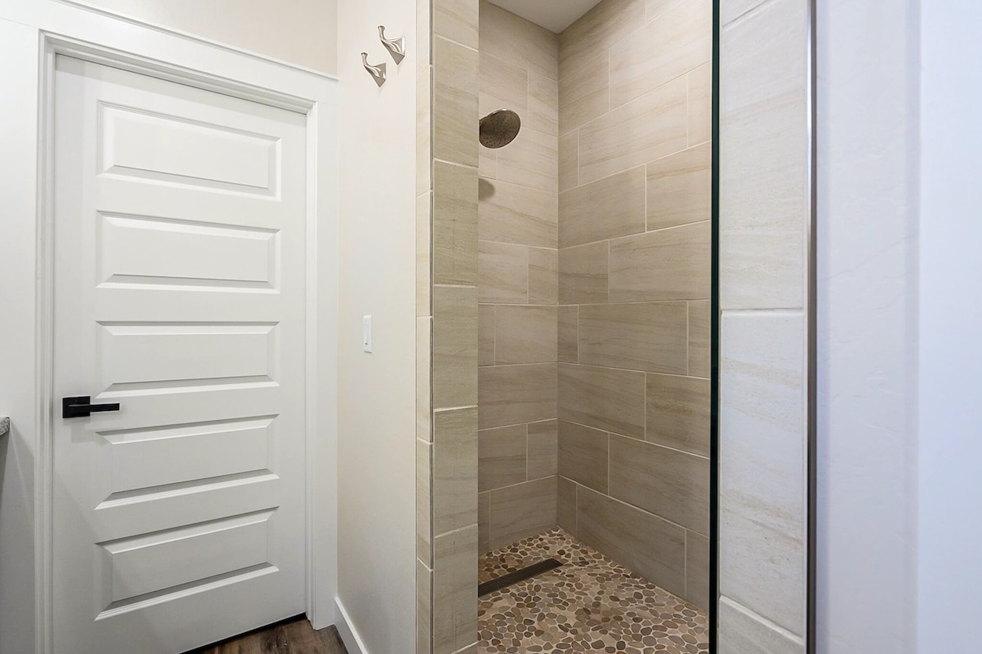 Step into relaxation — the spa-inspired walk-in shower offers a peaceful retreat after a day of adventure beneath the pines.