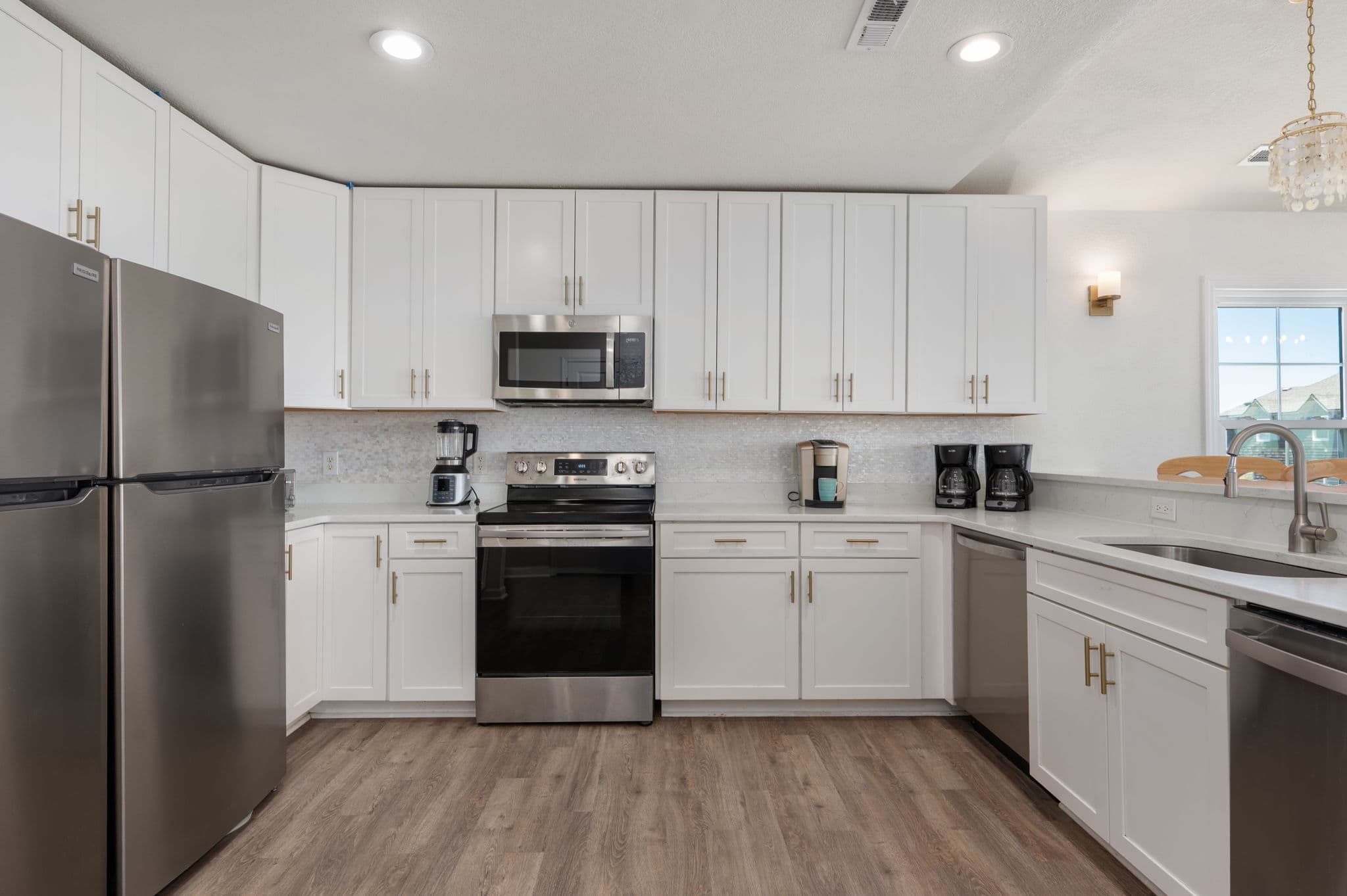 Bright White Cabinets, Coastal Tile & Premium Fixtures — Chef's Kitchen Goals | Coastline Haven, OBX